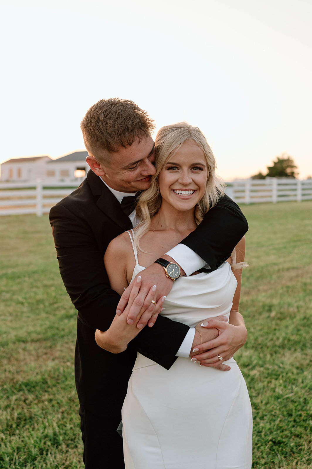 bride and groom smiling during golden hour portraits on their wedding day
