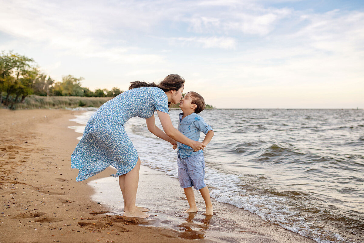 Family session located at the beach with mother in a dress