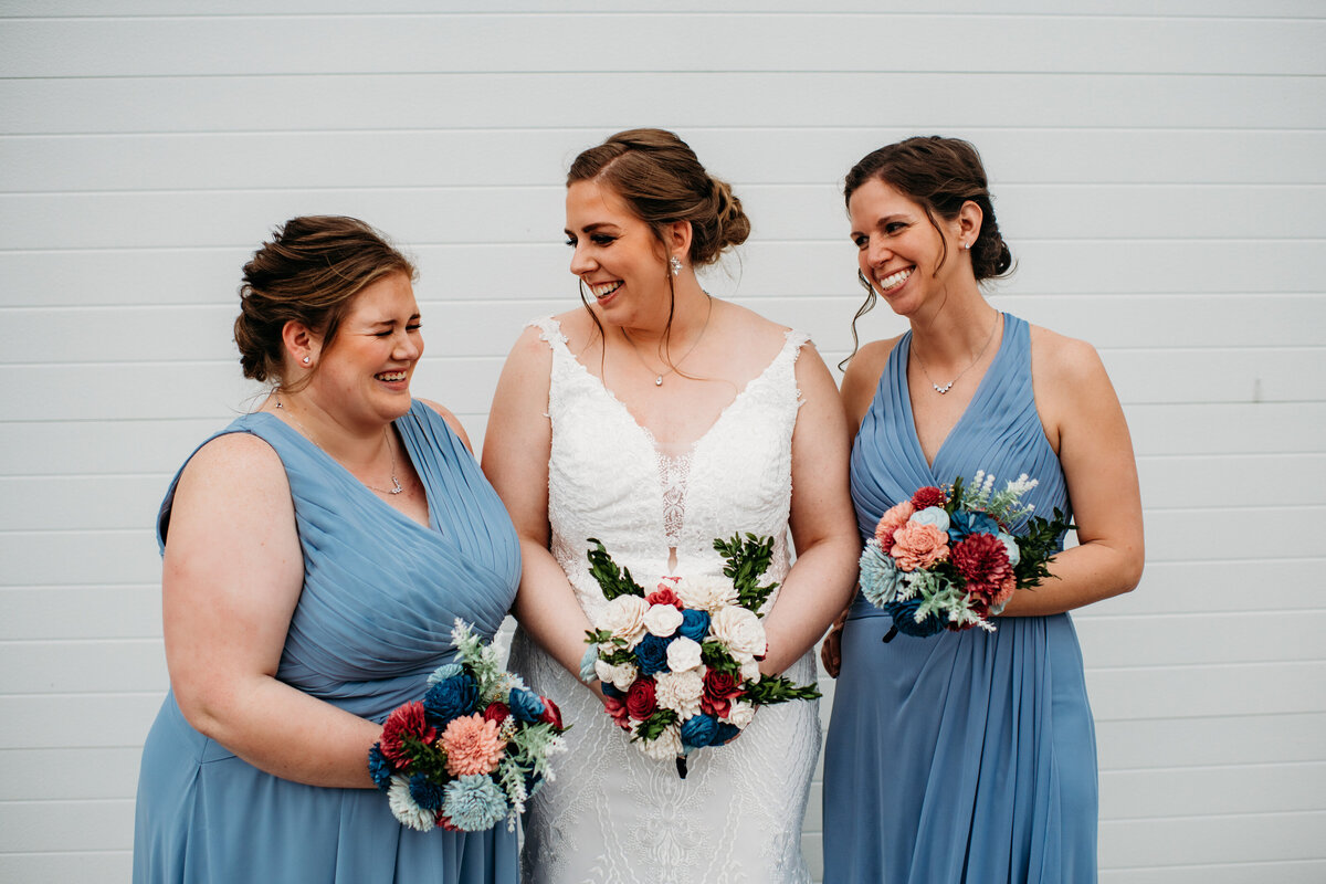 Bridesmaids  and bride smiling and laughing at each other
