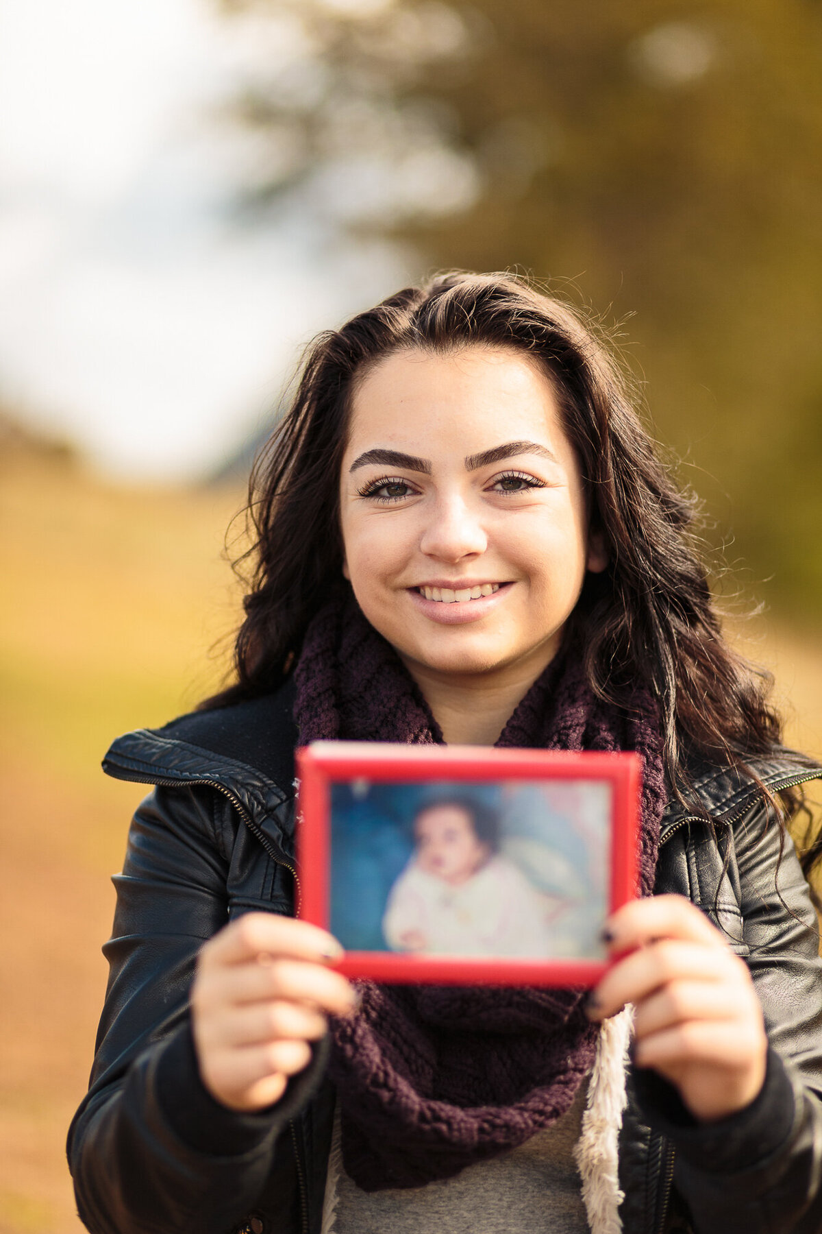 Color image of girl holding her baby picture
