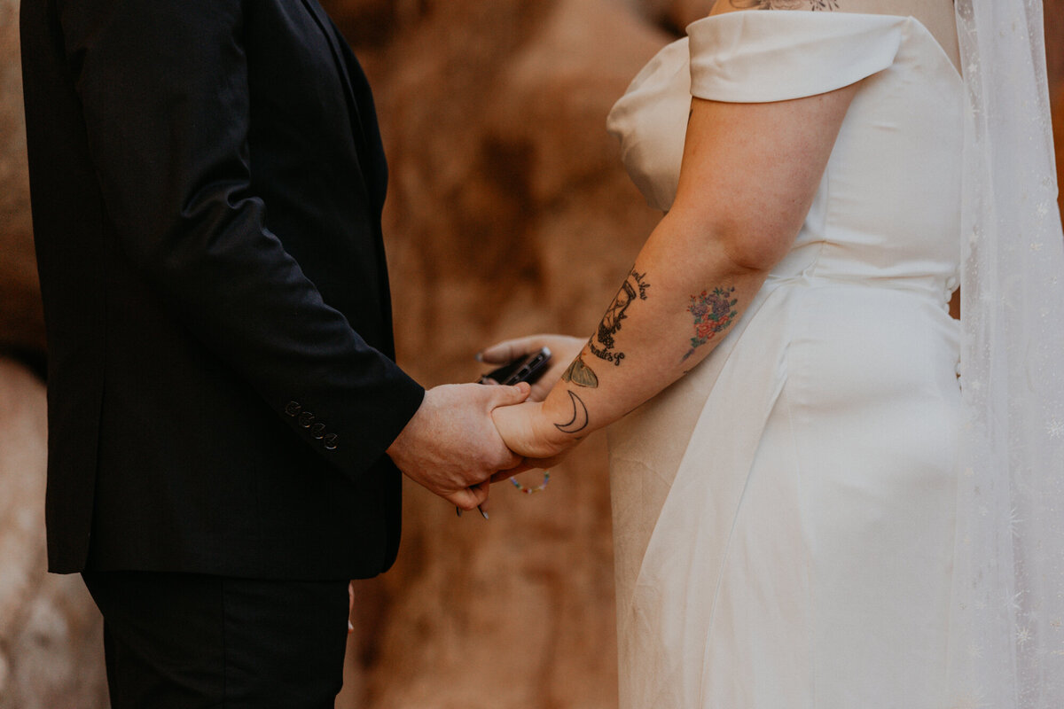 close up of bride and grooms hands holdin during their ceremony