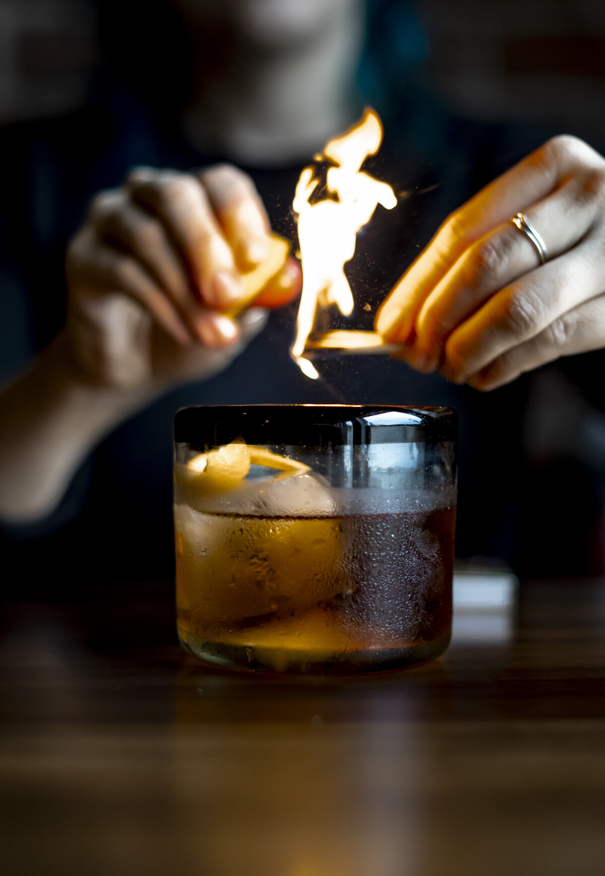 Match being struck over artisan cocktail as its made.