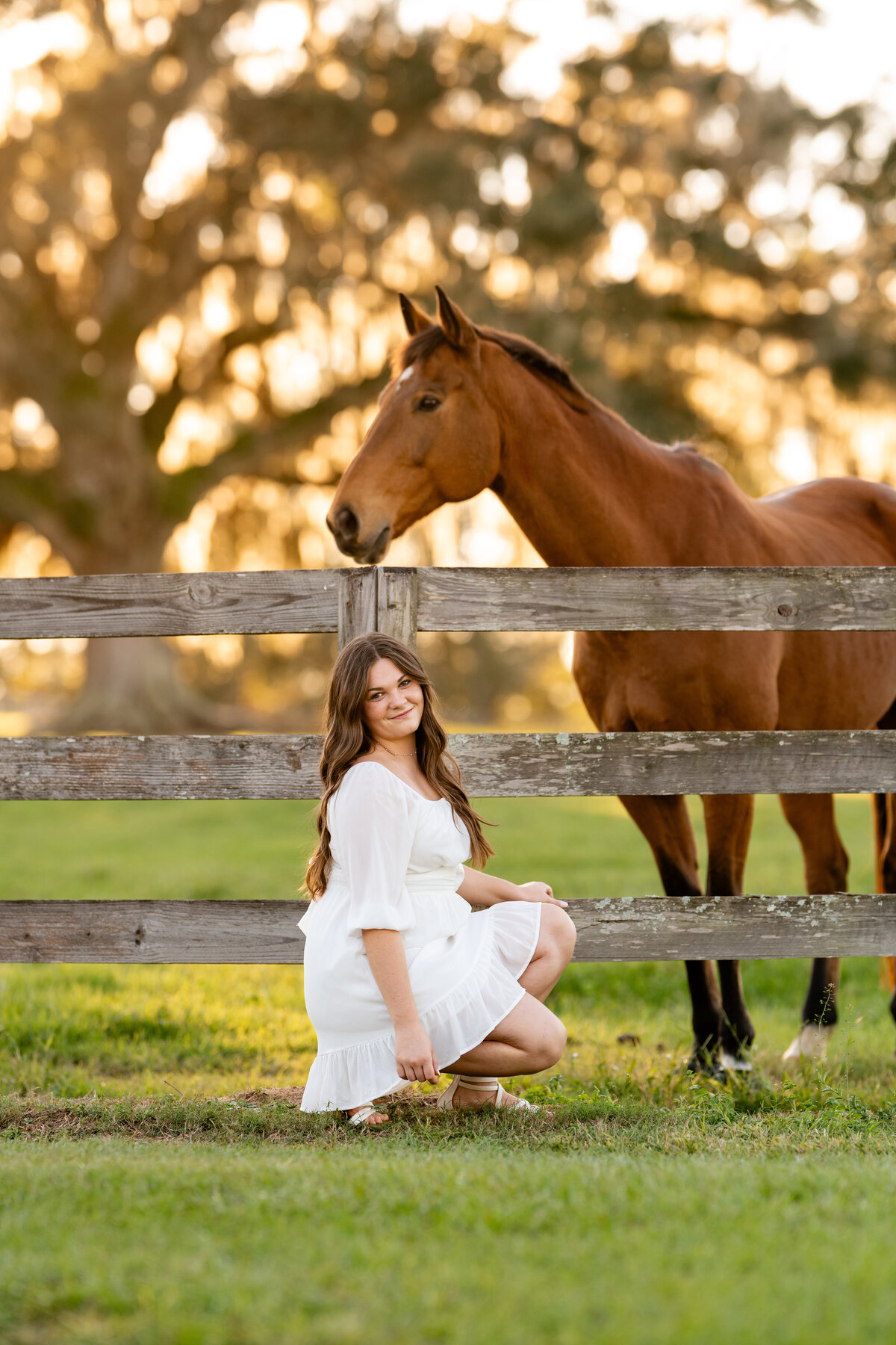 Monticello senior takes photos with horse in the background on a farm near Tallahassee, FL.