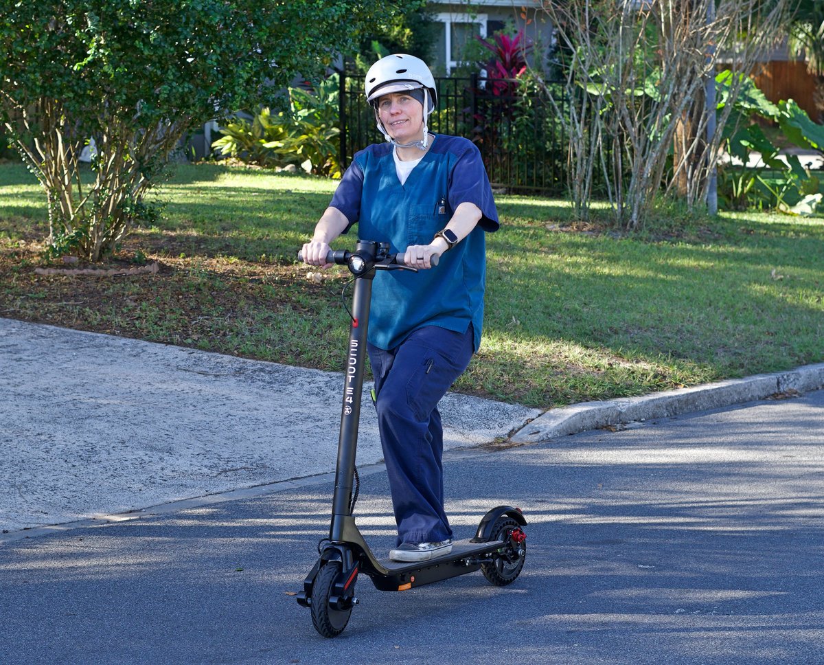 Lady with helmet on Scoot E-4