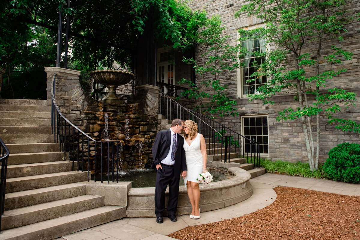 Couple standing by water feature at Cheekwood during their elopement photoshoot