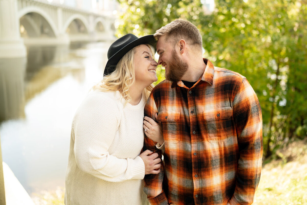 Msn and woman in sweater and flannel smile at each other.