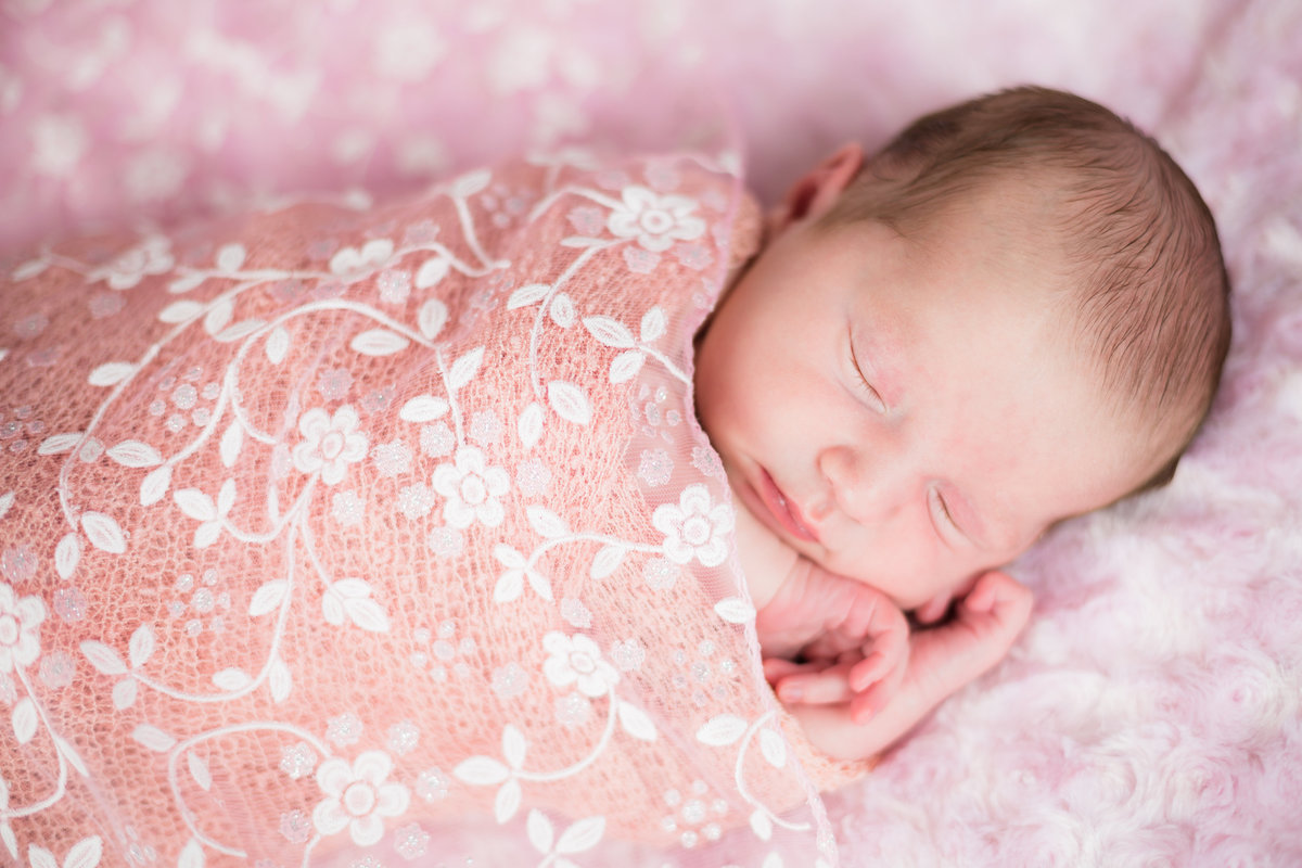 Newborn baby sleeping in pink