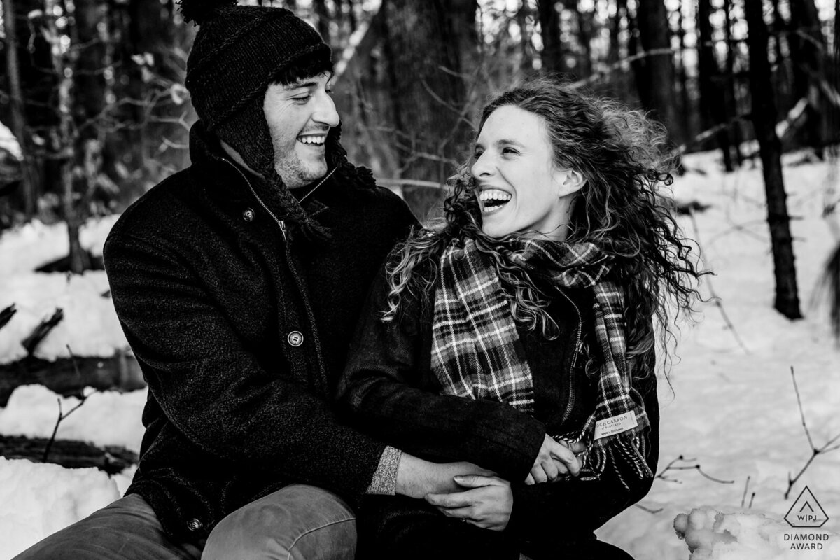 The Fells Reserve in the winter hosts the couple who play in the snow for their engagement session