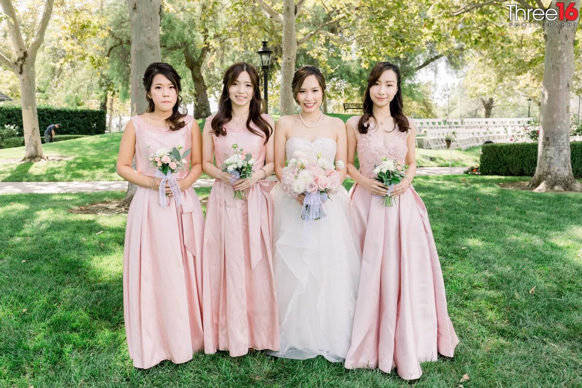 Bride poses for photos with her Bridesmaids