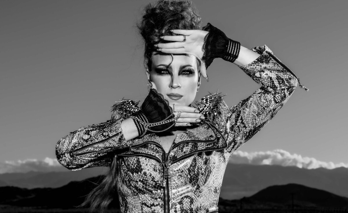 Women music black and white portrait Tarra Layne  hands framing face mountains with  clouds behind