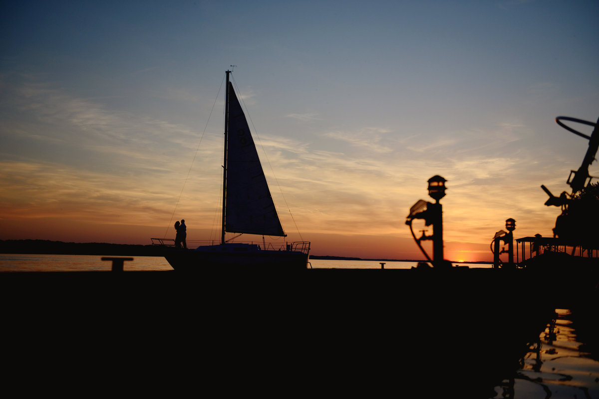 sunset silhouette at sailboat engagement session