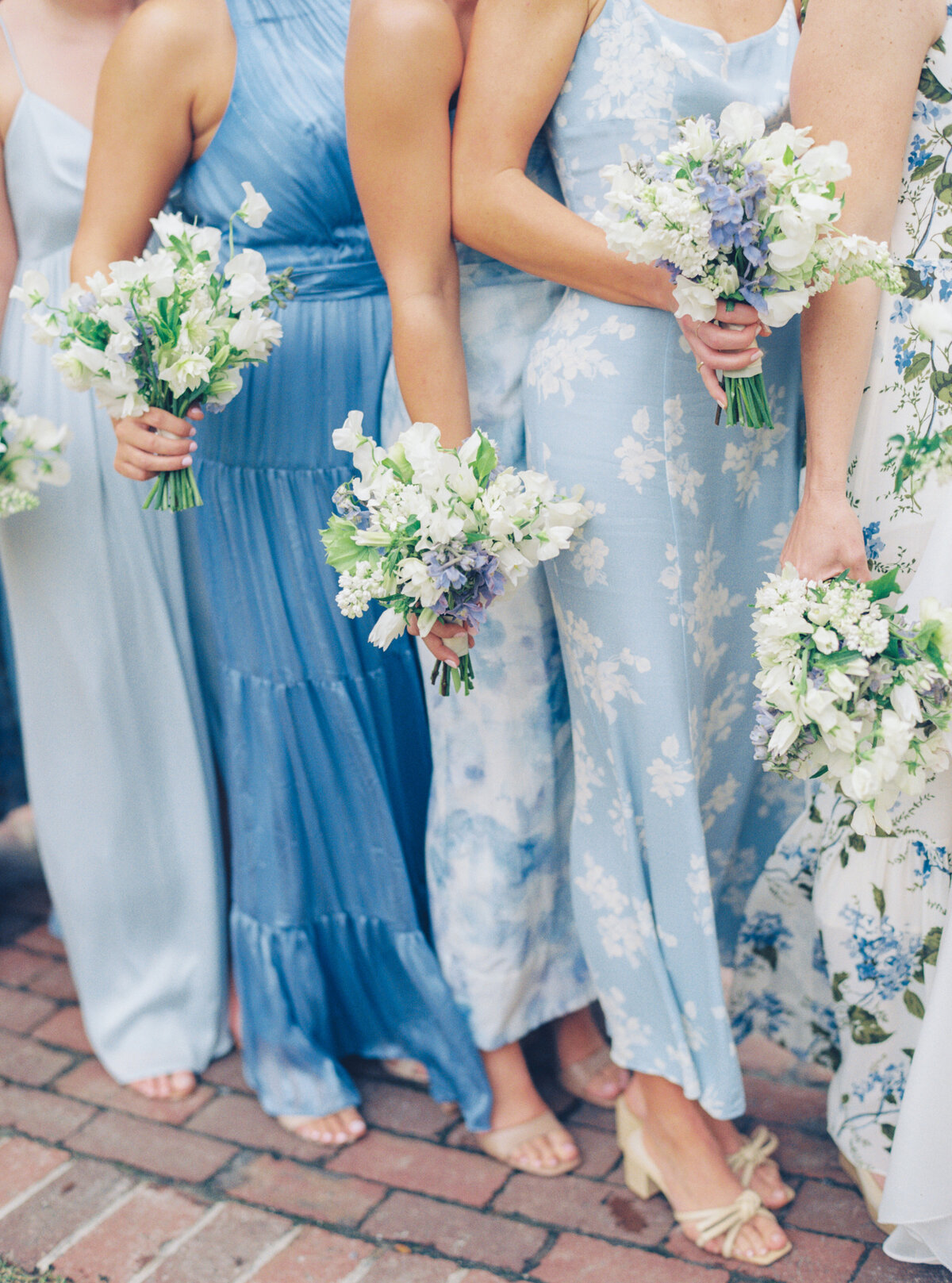 Mix-matched blue bridesmaids dresses. Spring wedding at Lowndes Grove.