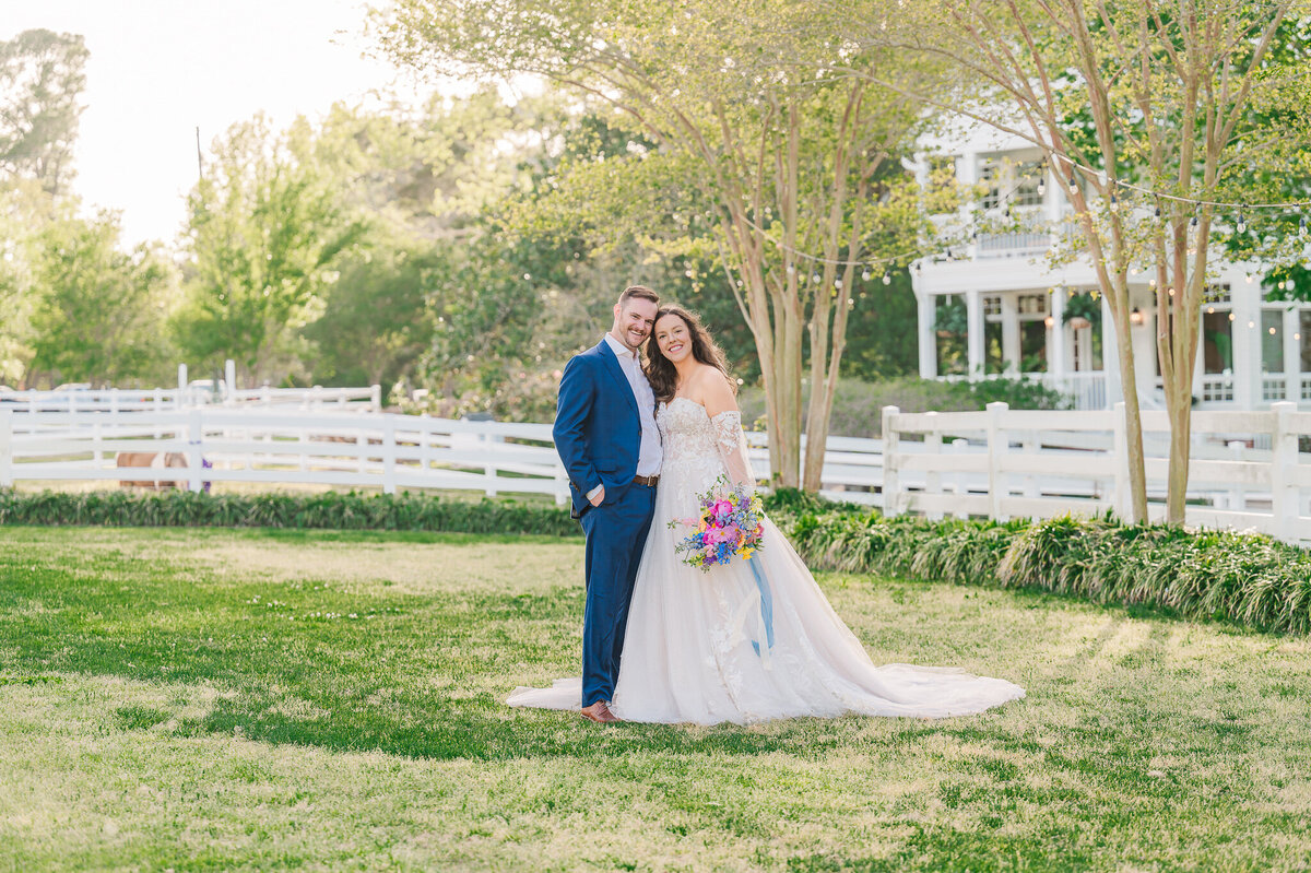 A newly married couple at sunset at their historic estate venue while enjoying their Raleigh wedding photos