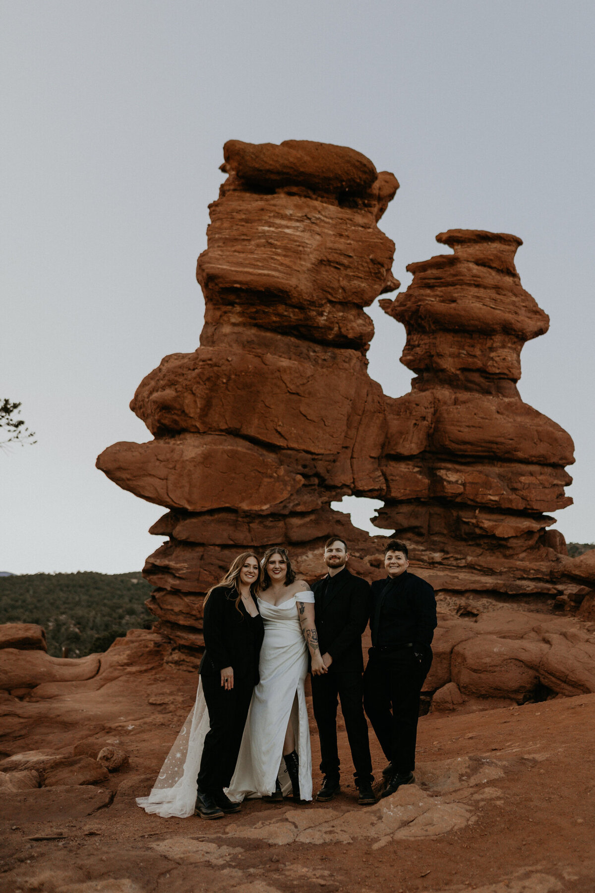 bride and groom with their two guests at red rocks in Colorado