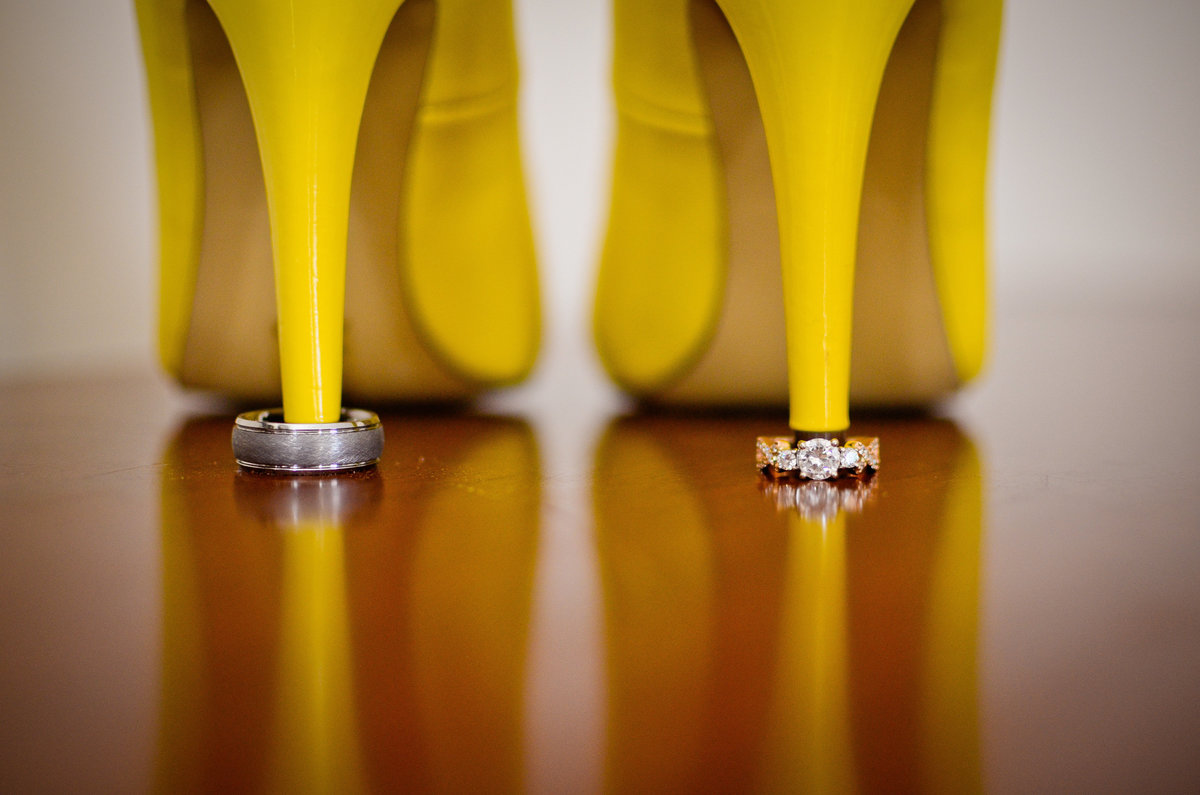 close up of bride colorful heels and wedding bands