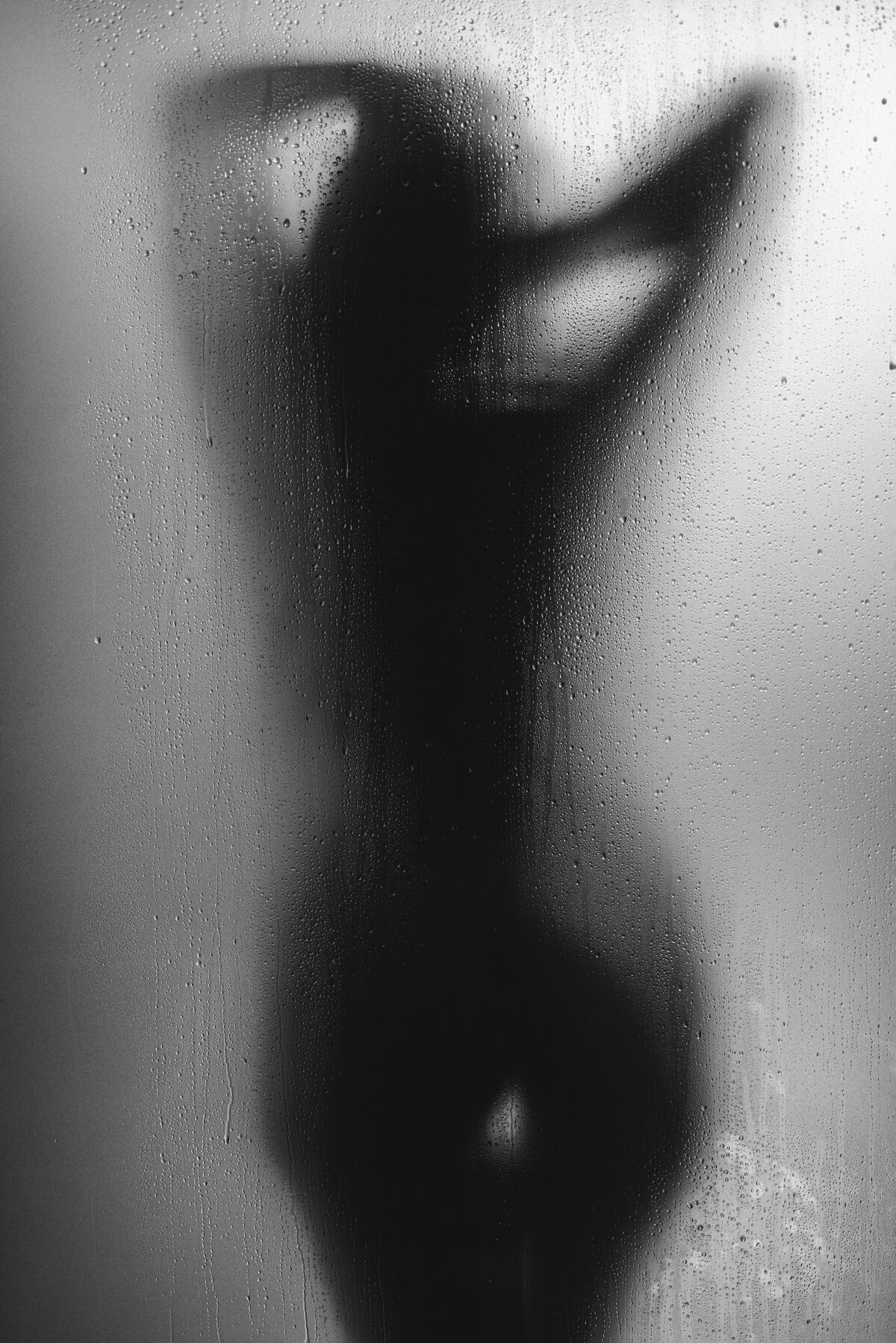 Woman silhouette behind a shower door