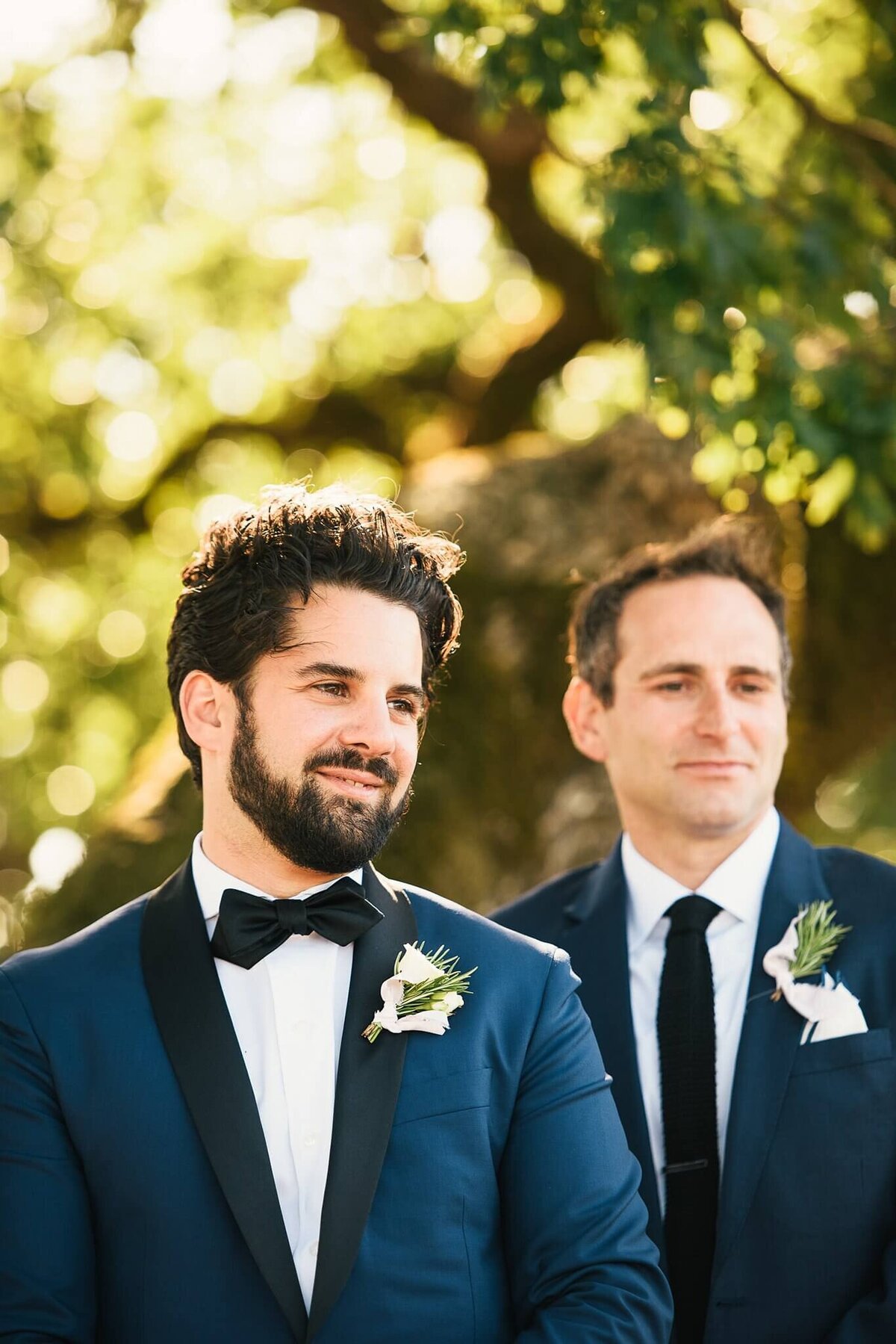 groom looking at bride coming down the aisle
