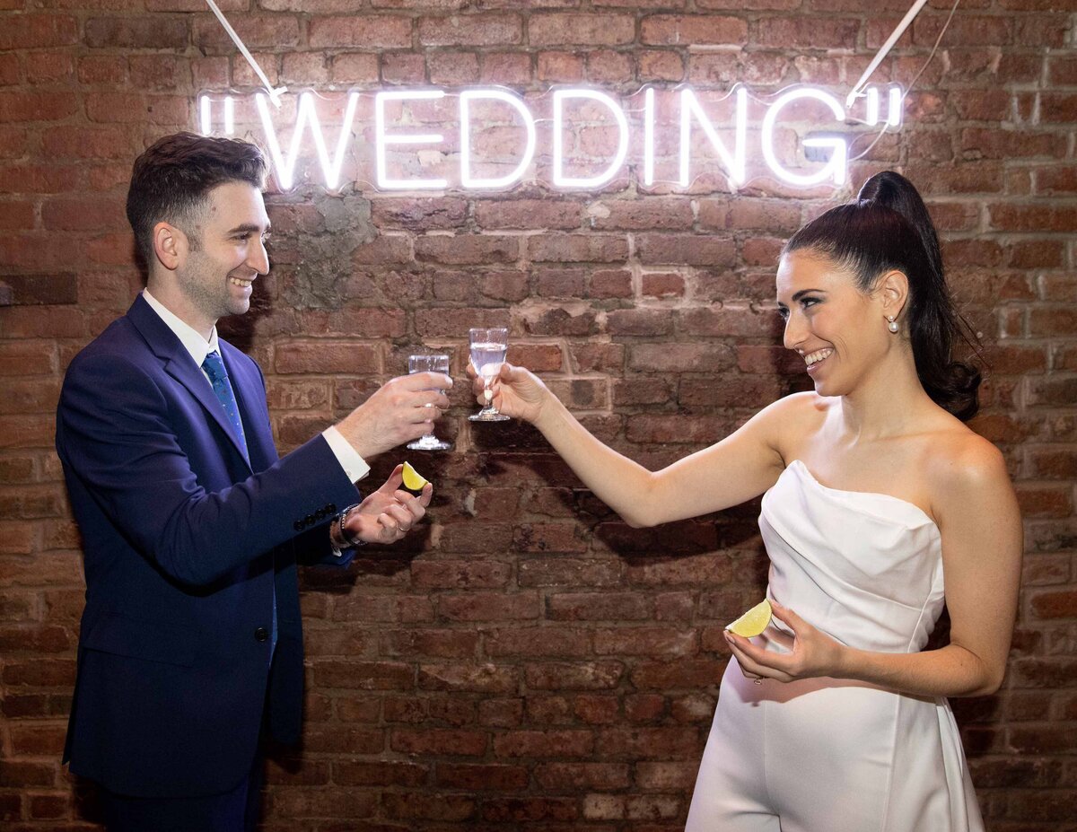 A bride and groom toasting each other.