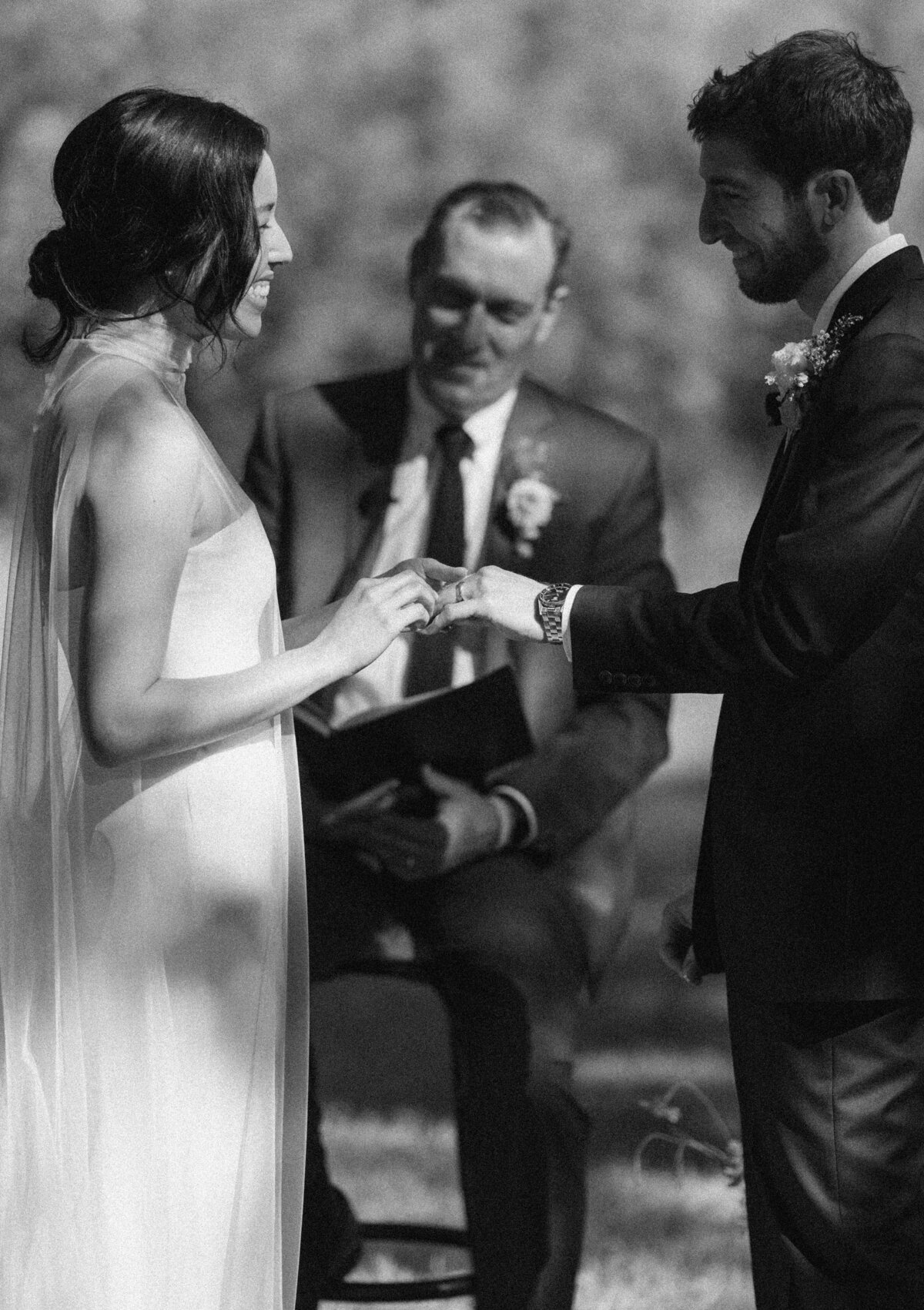 Bride placing ring on grooms finger at  Mattie's Austin wedding