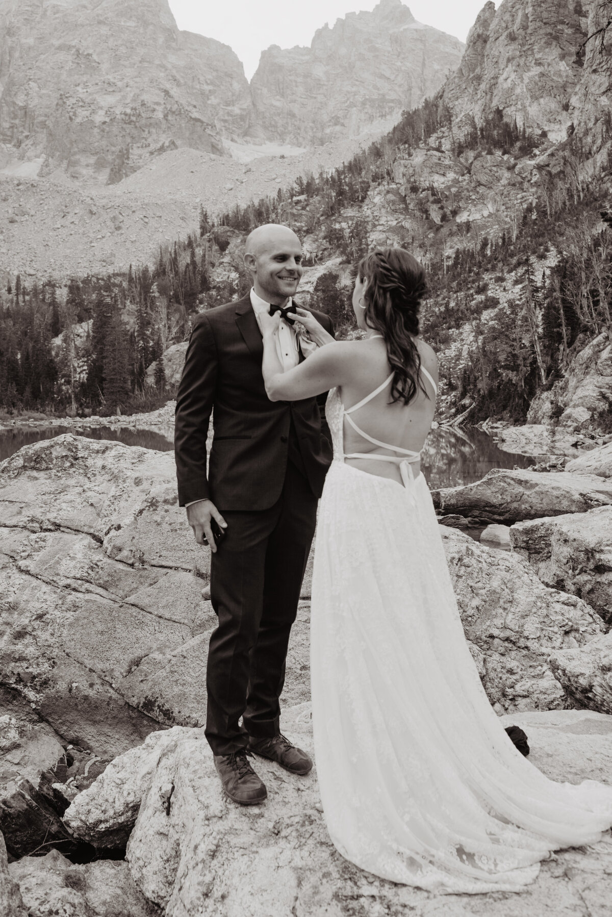 Jackson Hole photographers capture bride helping groom adjust bowtie