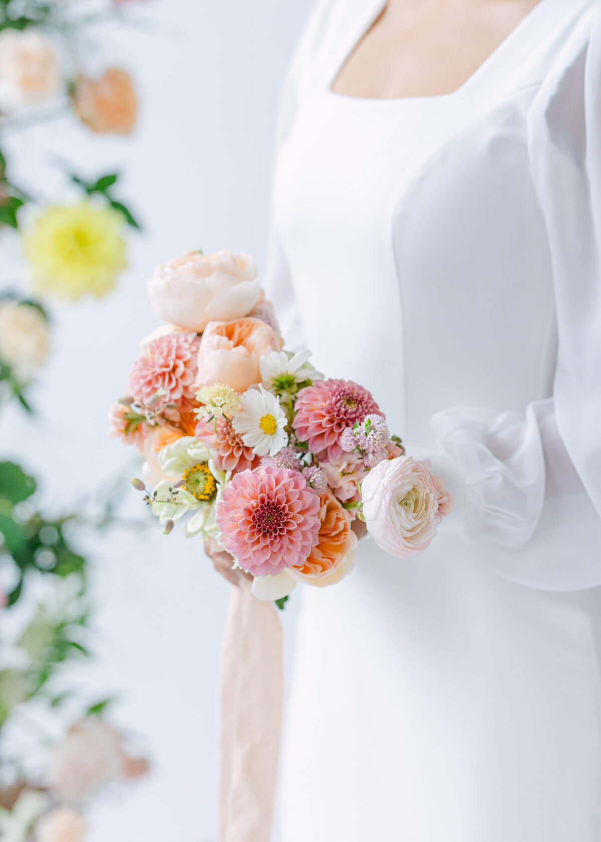 bride holding peach toned bridal bouquet