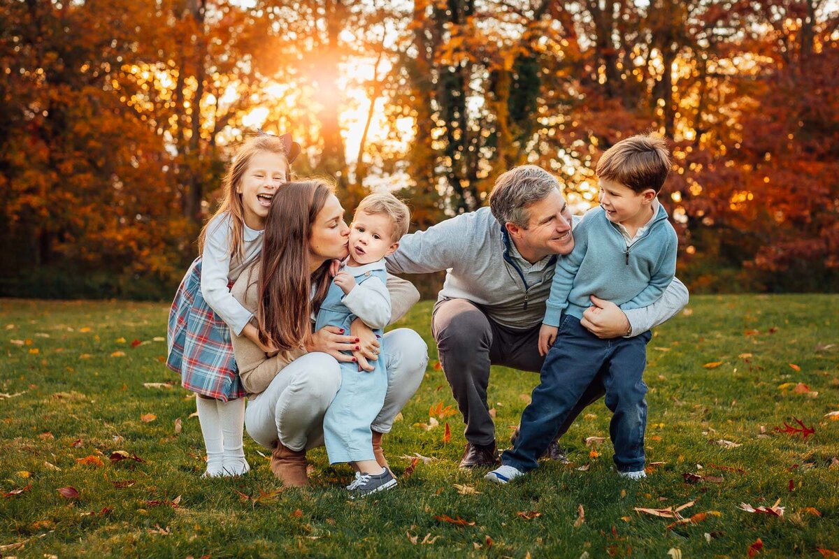 family hugging with sunset behind during long island family photo session