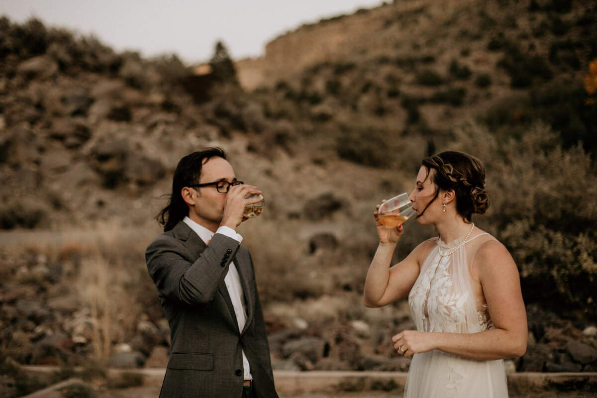 eloping couple drinking champagne in Taos