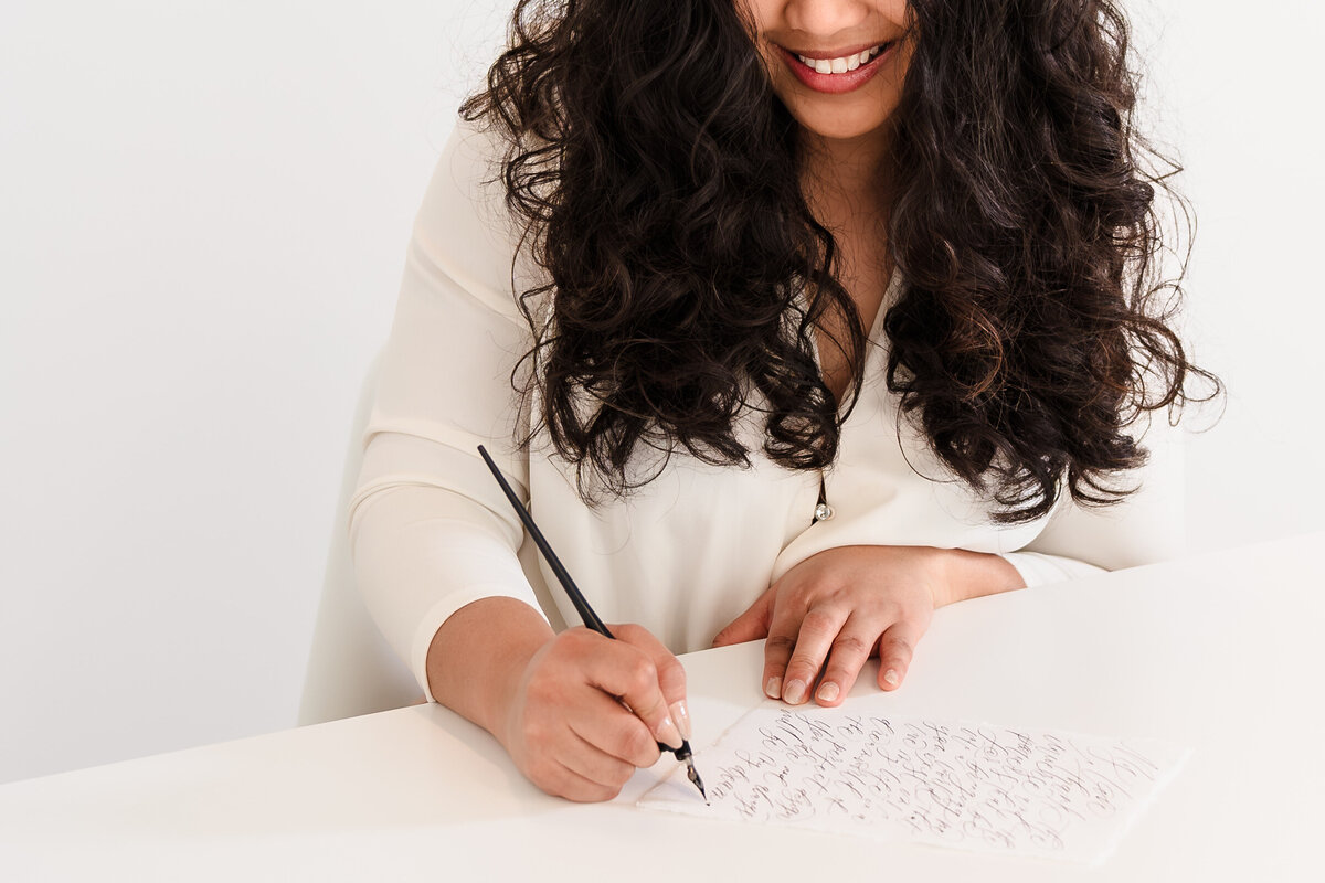brand photo of a calligrapher  focuses  on her hands