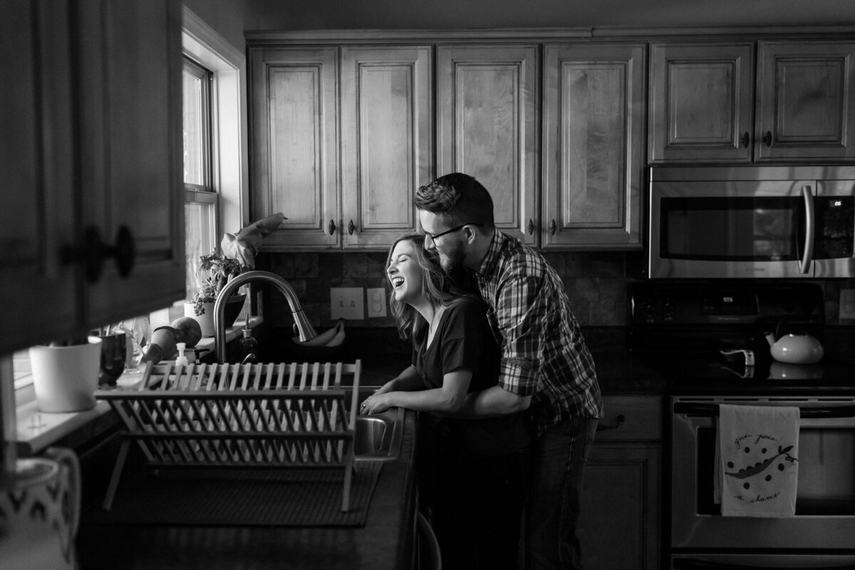 couple washing the dishes in a kitchen in lifestyle in-home shoot