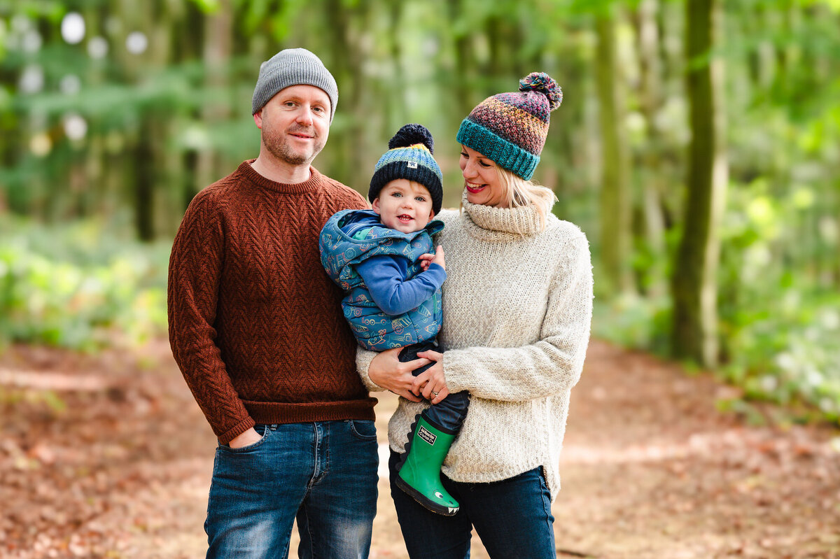 Parents with their son during autumn family photoshoot at barnsdale woods with Amanda Forman Photography