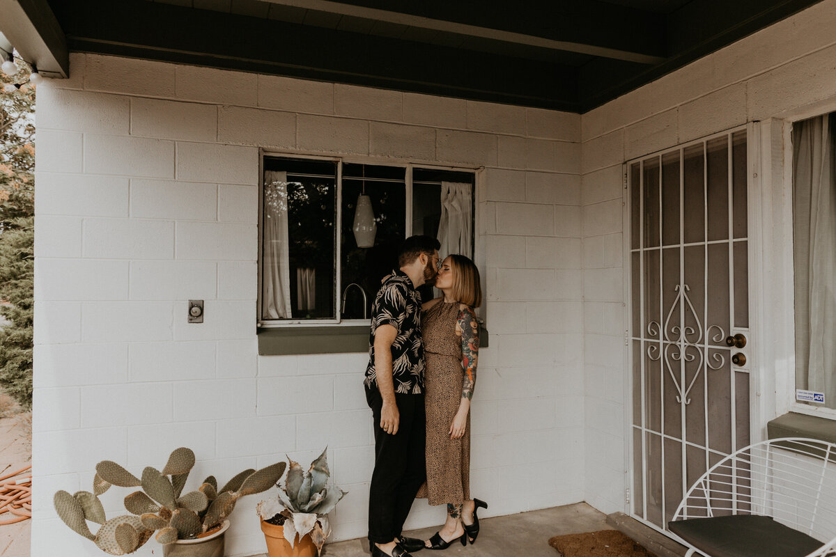 engaged couple standing on  southwest porch together
