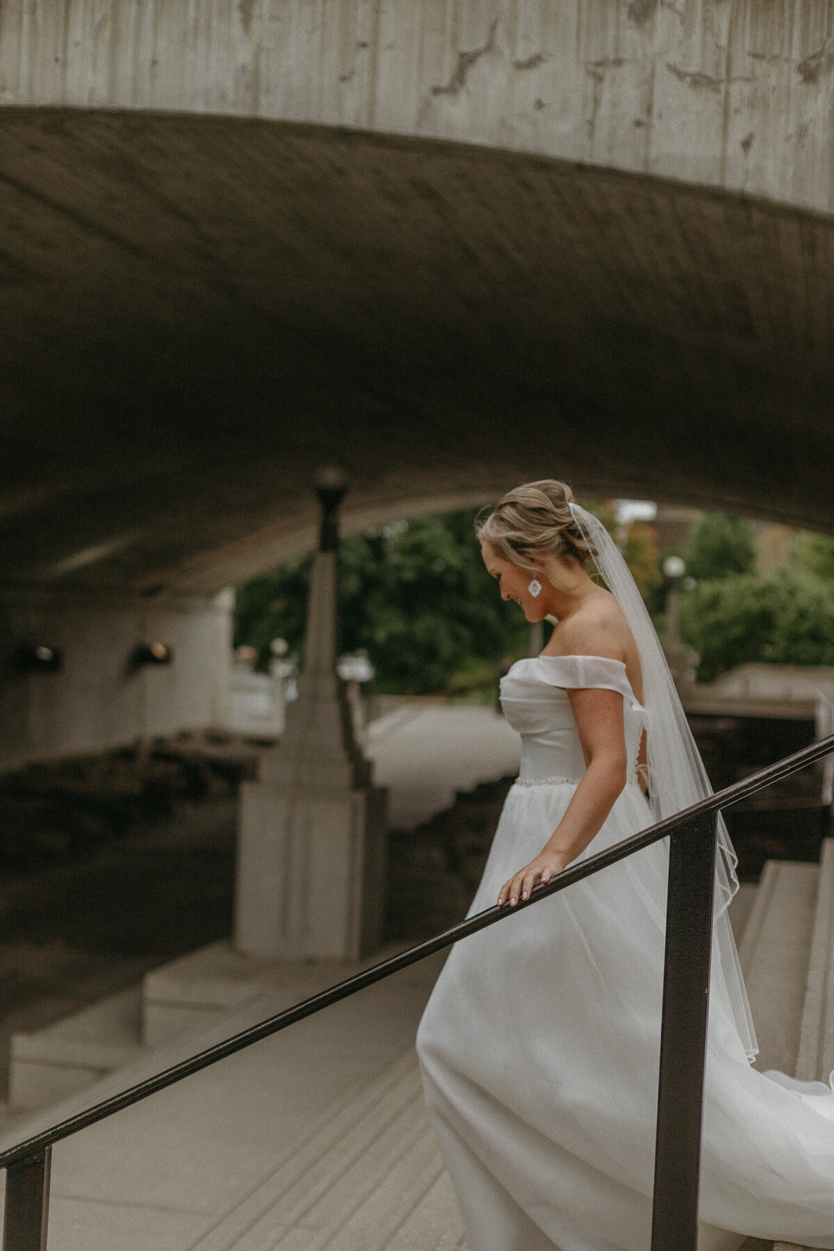 Bridal walks down stairs beside canal in downtown Ottawa for first look photos