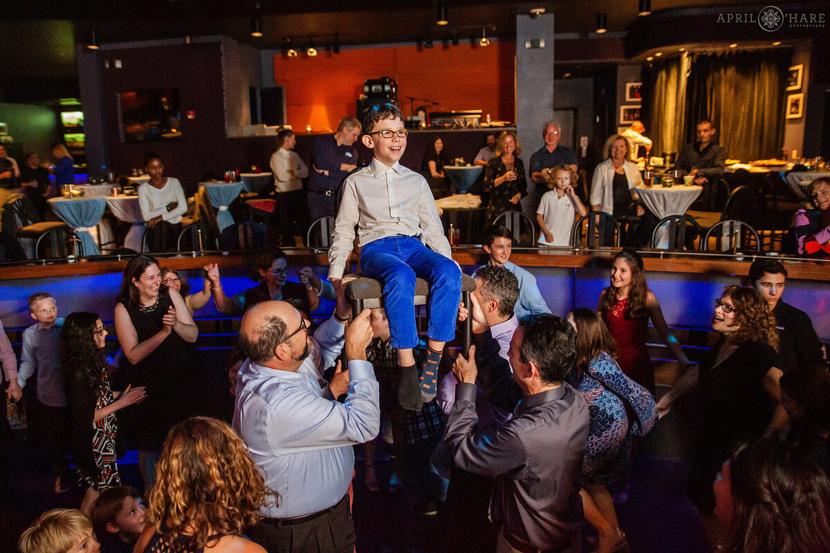 Kid Sits on a Chair During Horah Dance at a Denver Bat Mitzvah Party