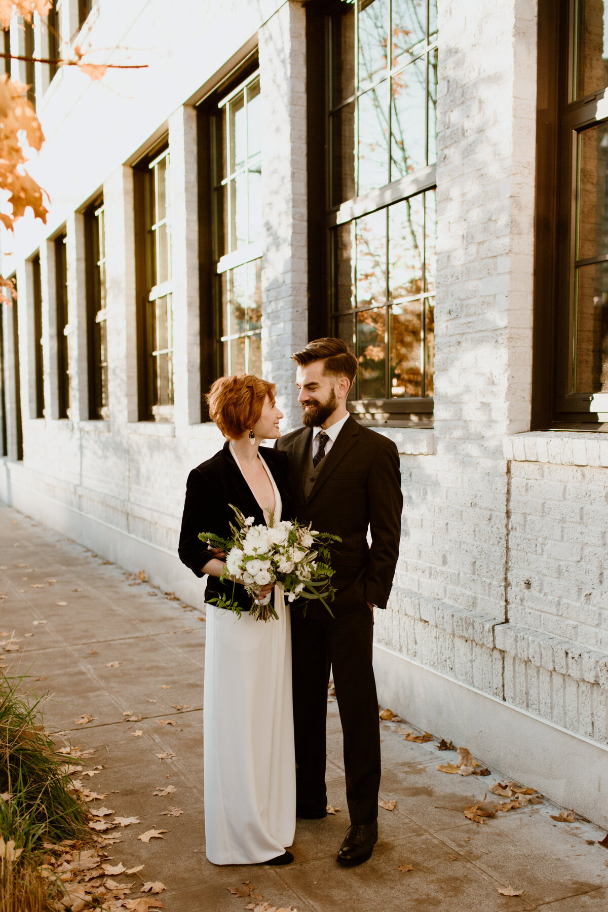 An urban sunset candid of a couple in wedding attire captured by Fort Worth wedding photographer, Megan Christine Studio