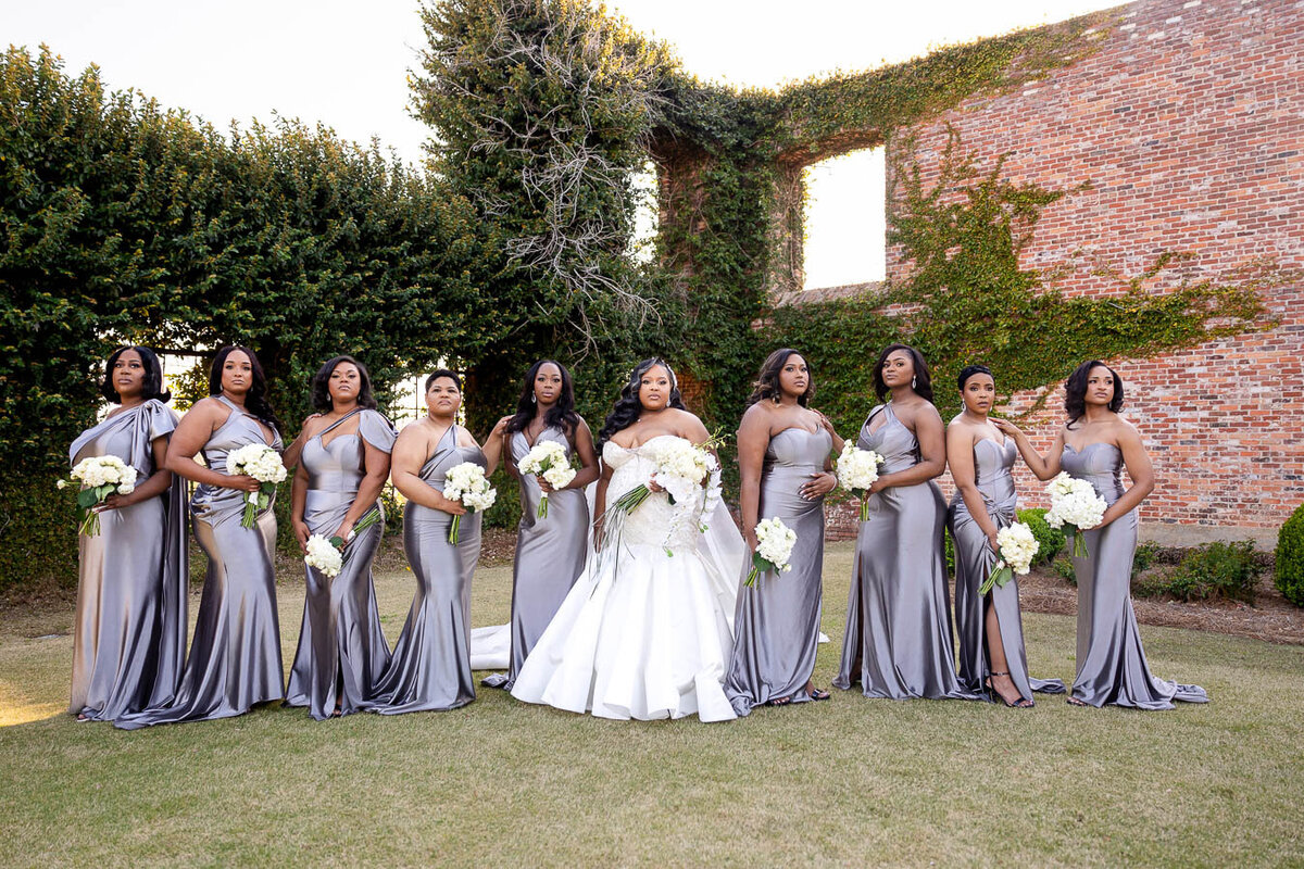 Bridal party posing outdoors at Bibb Mill Event Center, captured in natural true-to-color photography