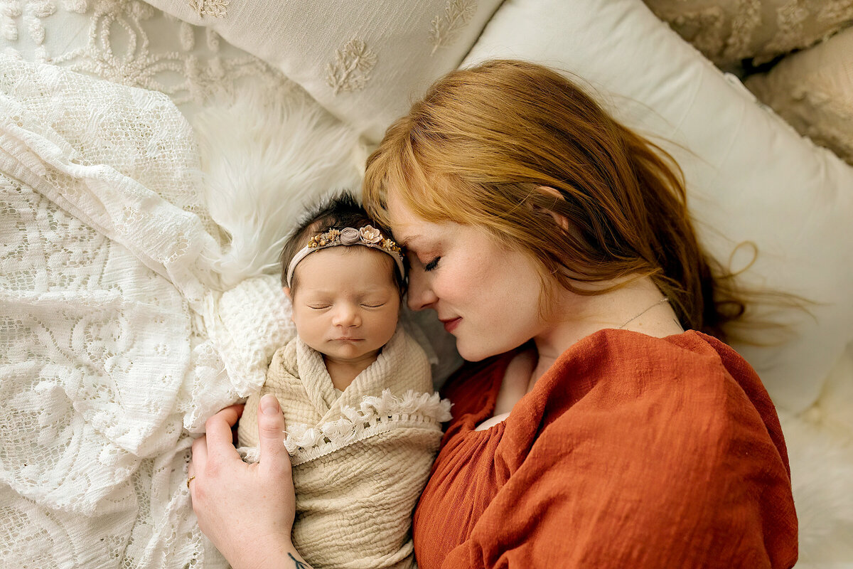 Mom and baby in newborn photography studio