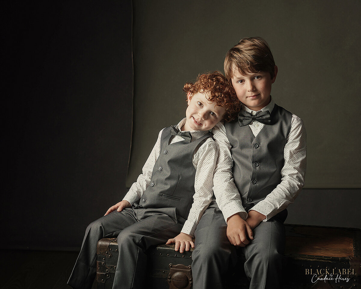two brothers in 3 piece suits photographed luxury style