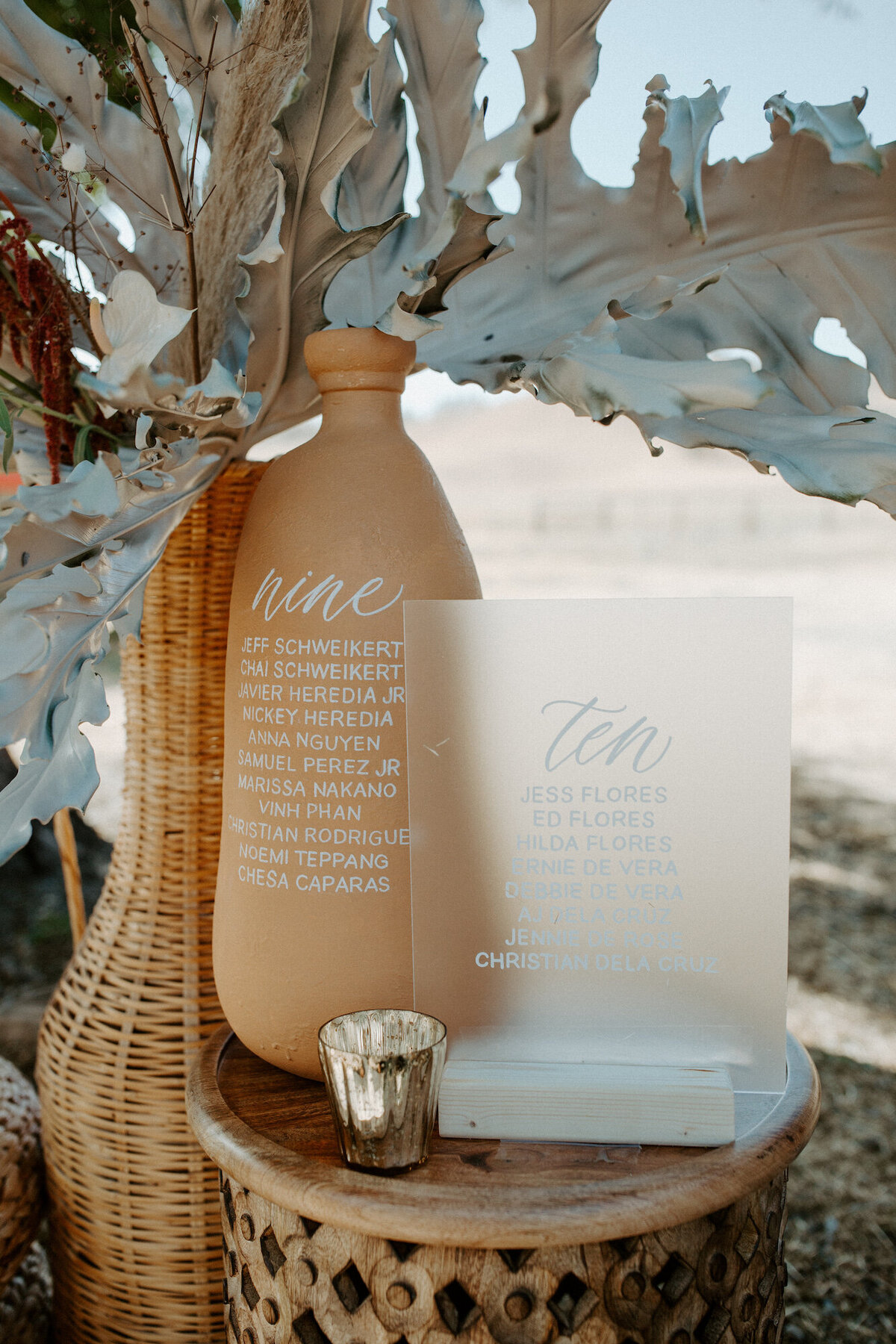 Terra cotta jug and acrylic seating chart decorated with dried florals