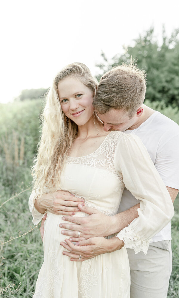 Pregnant couple hug at Smith Park in Brentwood By Nashville maternity photographer Kristie Lloyd