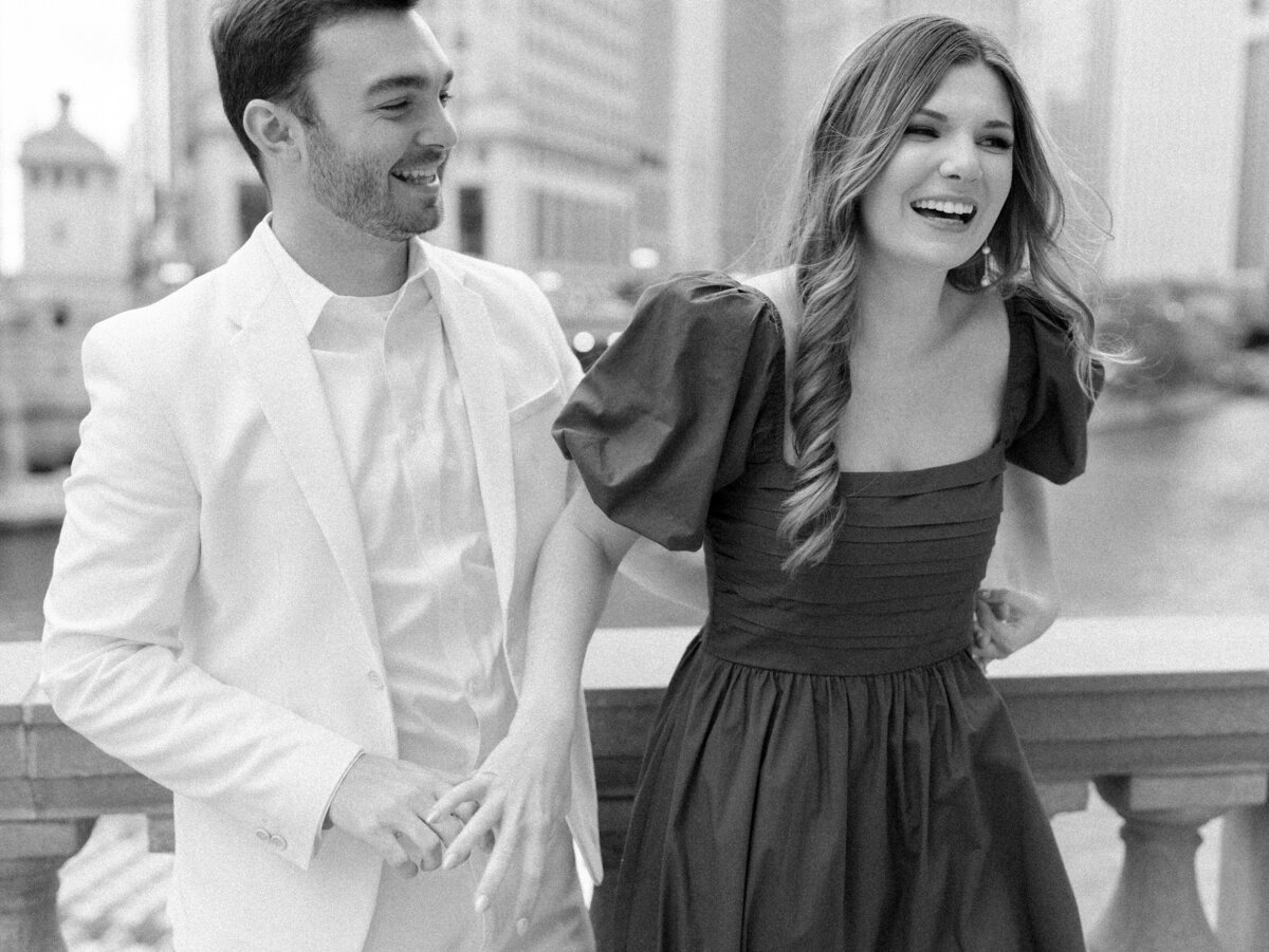 Bride and groom laughing in city photographed by Chicago editorial wedding photographer Arielle Peters