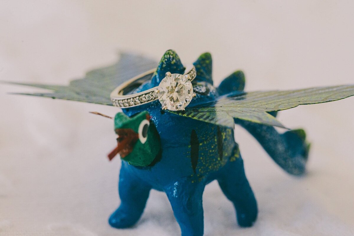 wedding ring on a small dragon toy