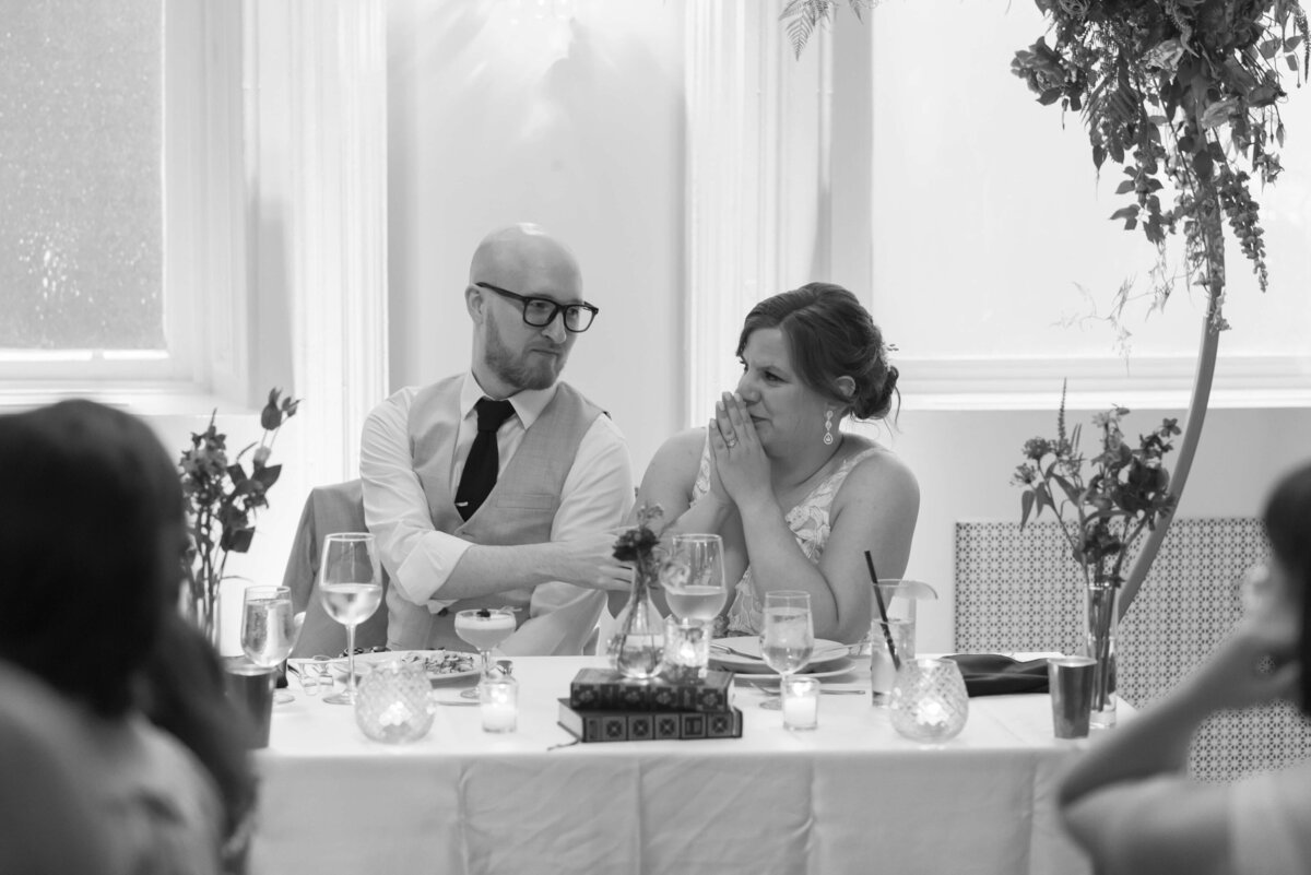 Bride and groom at sweetheatt table at  at Halifax Club wedding in Nova Scotia