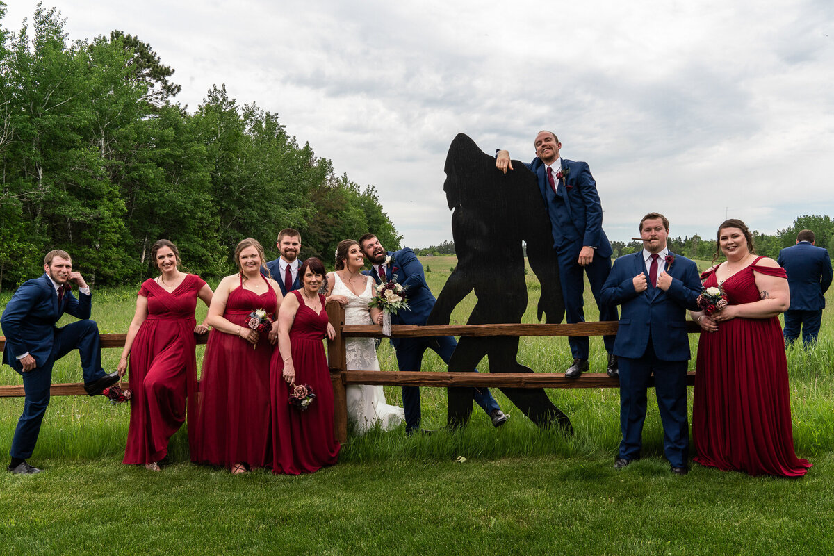 Wedding party poses next to a Bigfoot statue in Minnesota,