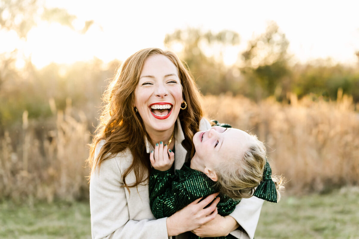Stunning sunset photo with mother and daughter laughing during session near Chicago, IL.