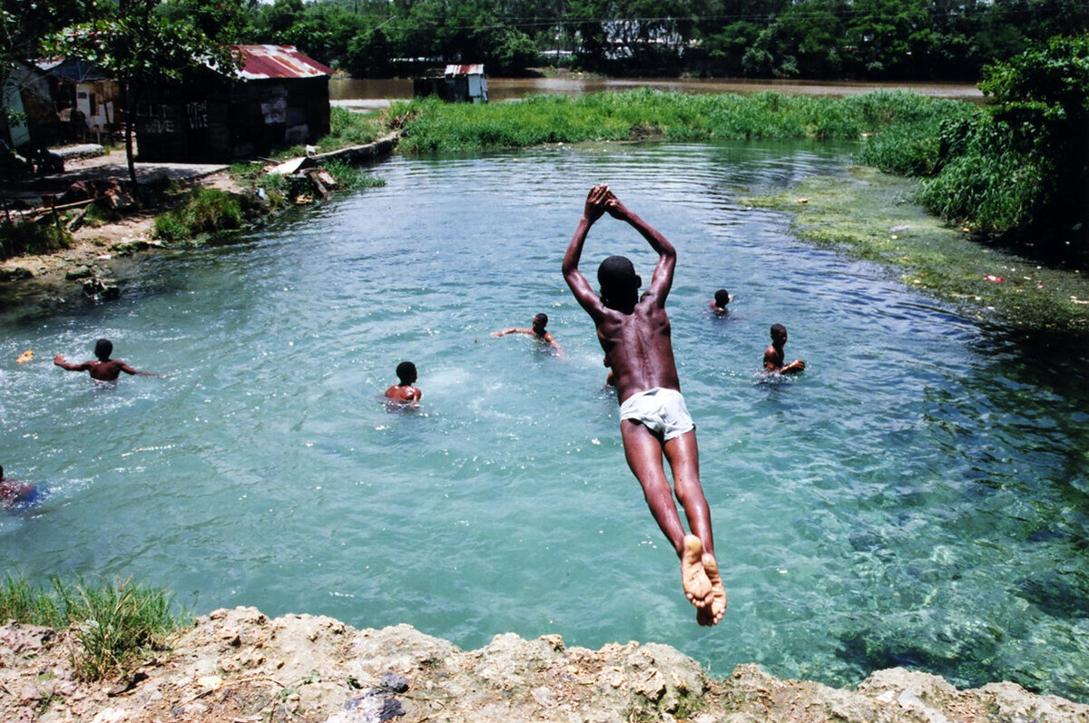 A child jumps into water at fresh water spring in La Zurza, Dominican Republic.