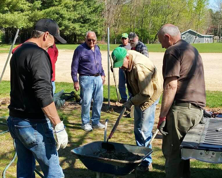 The men's service group replaces a fence at Bartlett Chapel