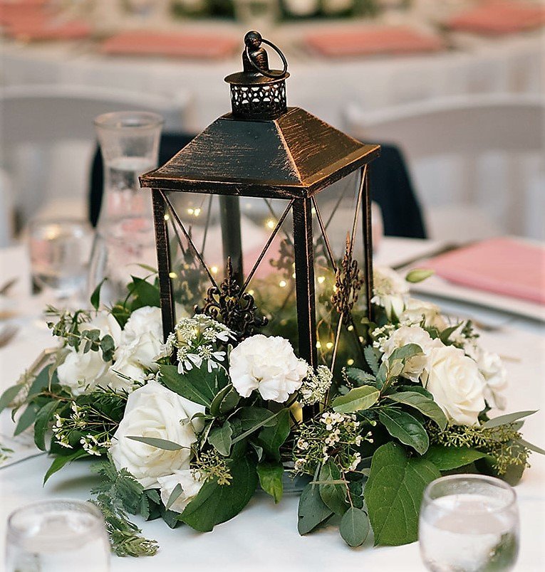 floral centerpiece with lantern and fairy lights