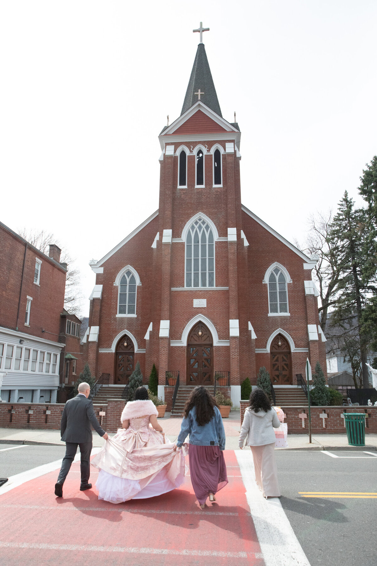 family of four walk toward Saint Peter's Church Haverstraw quinceanera photographer Rockland County Milestone Images