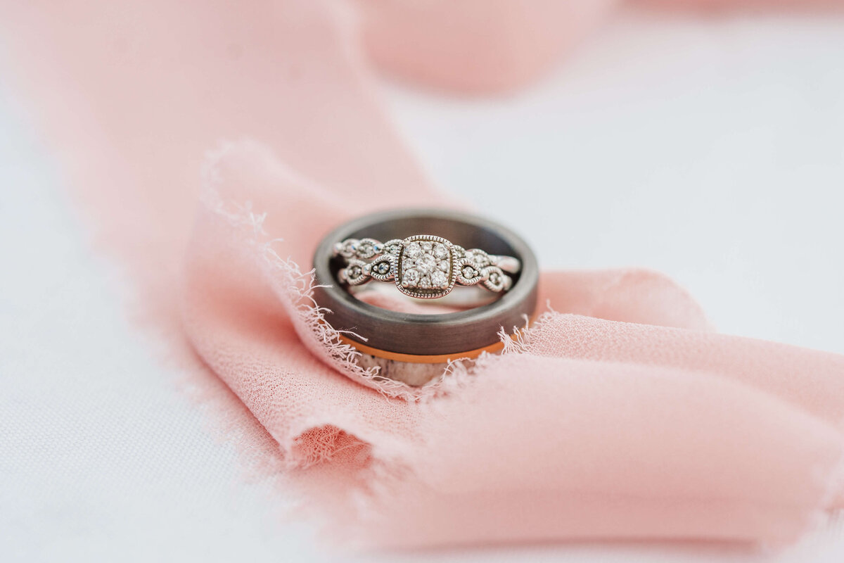 Bridge and grooms rings on top of pretty pink ribbon