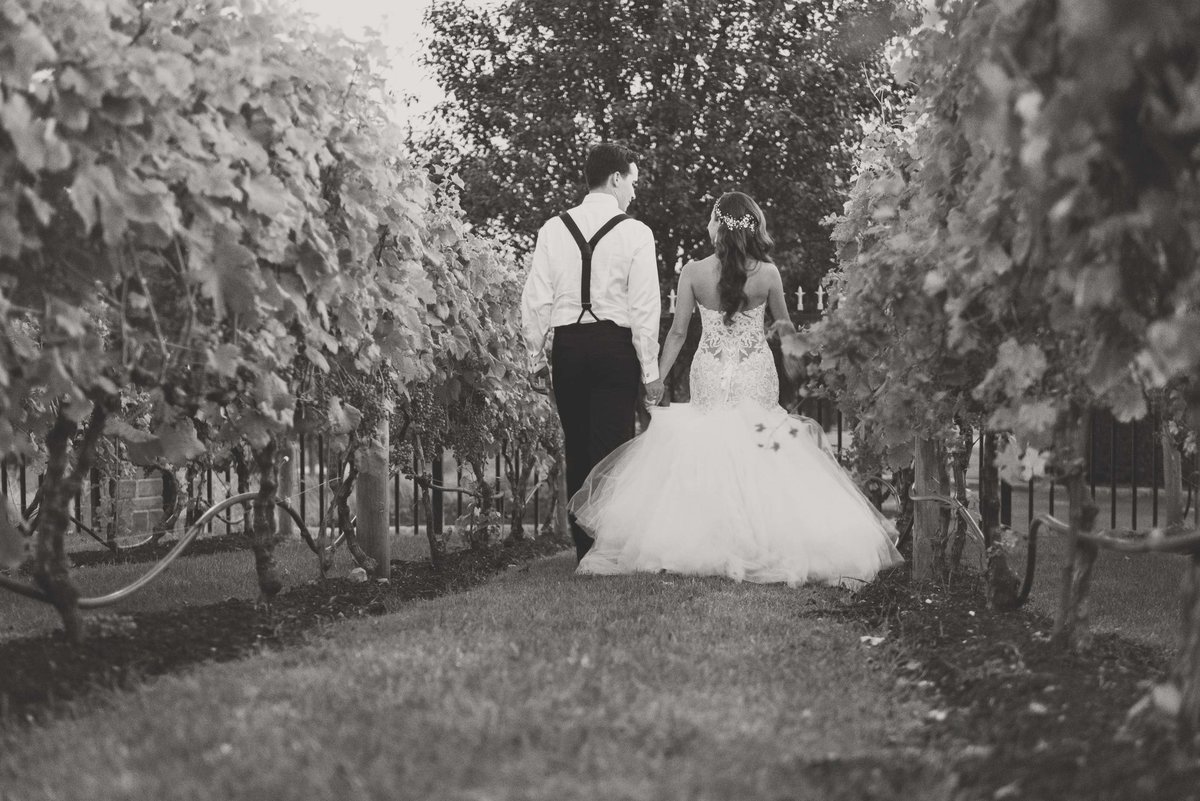 Bride and groom walking the vineyards at Giorgio's Baiting Hollow
